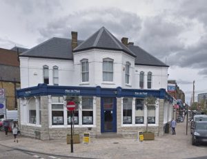 whitewashed 2-storey building with large hexagonal bay window