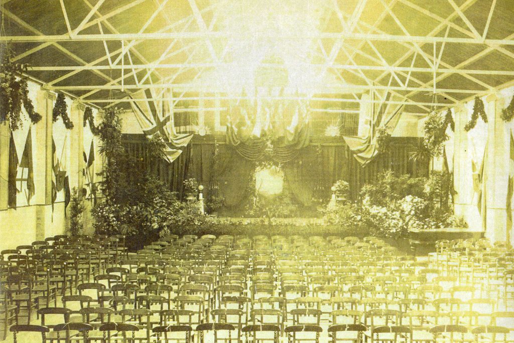 Hall with decorated stage and lots of chairs