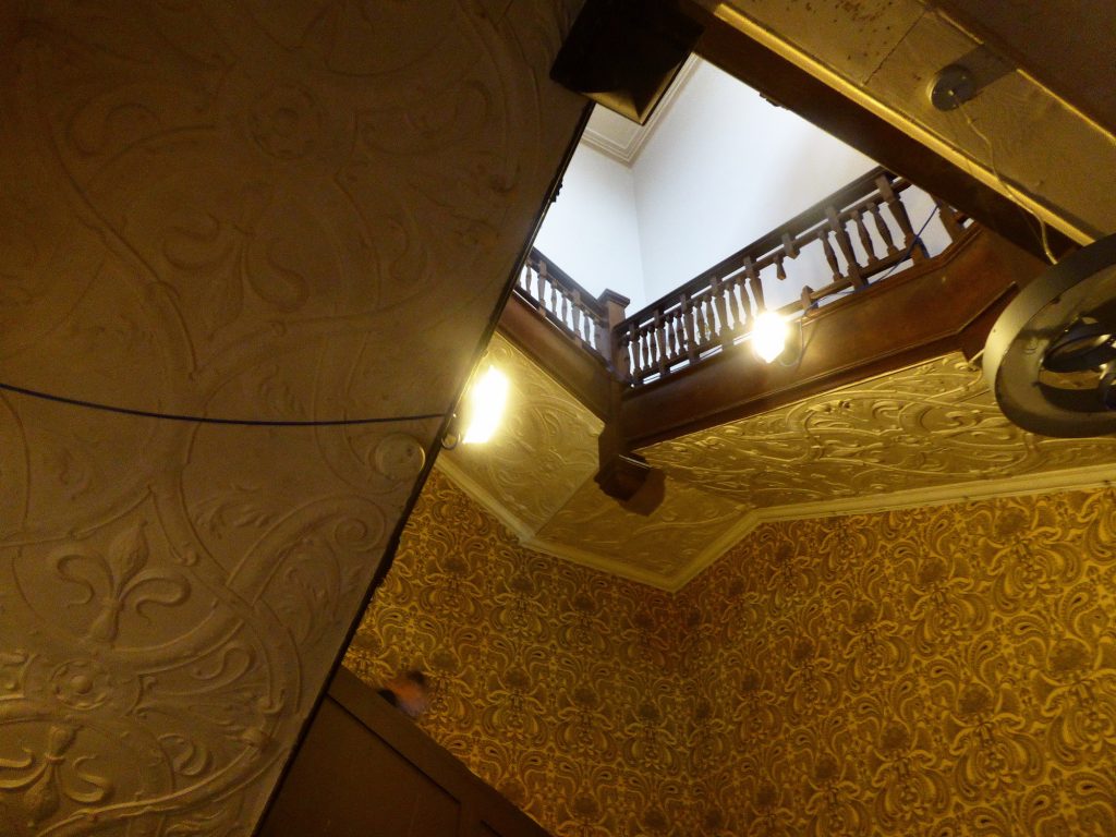 wooden stairs with patterned plaster undersides