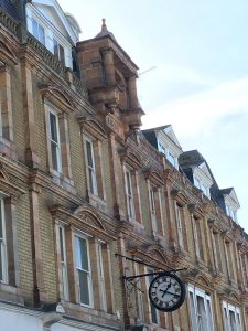 parade of shops in yellow stone in french classic architecture