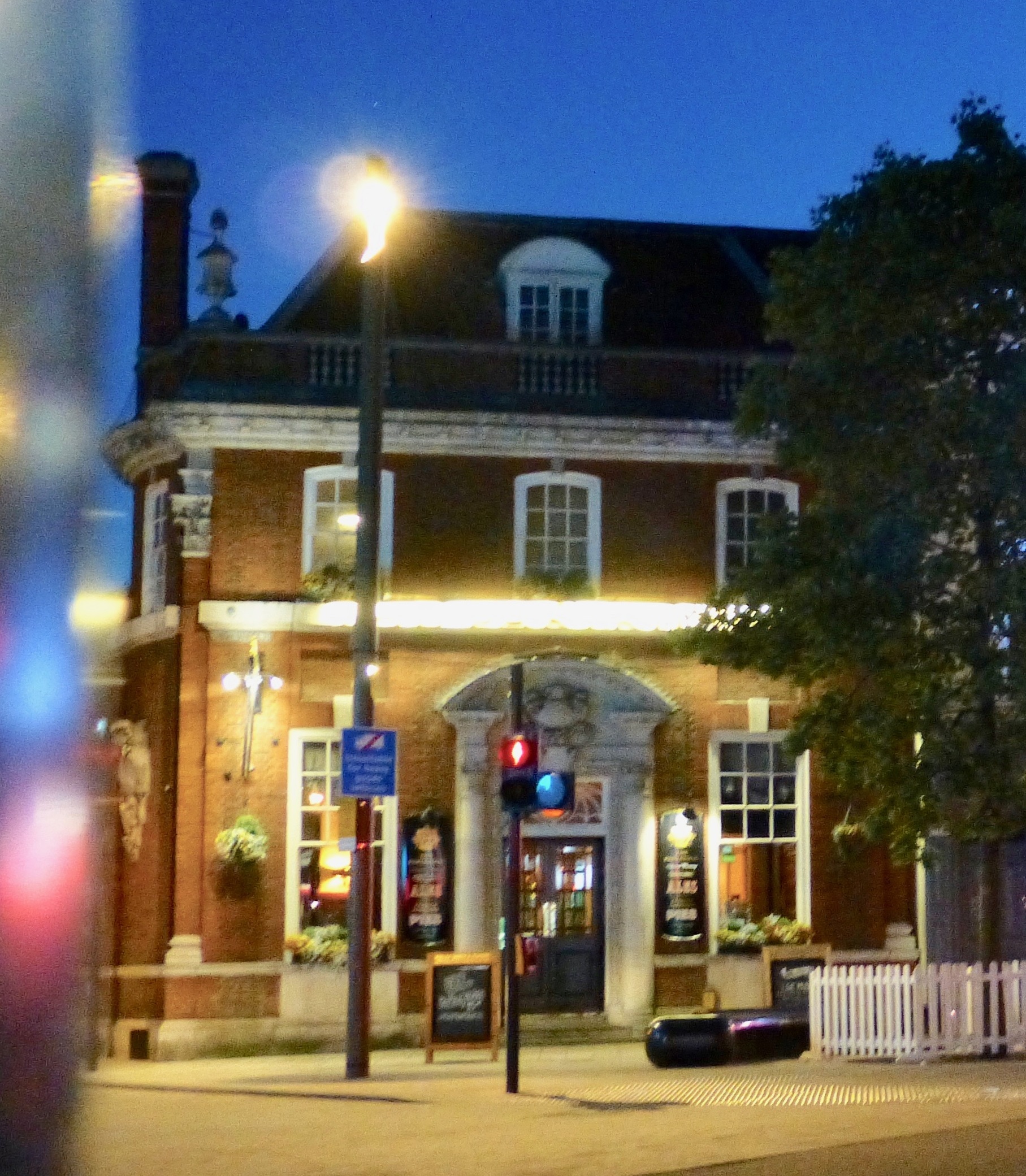 nice stone and brick building with ornate stone doorway and pediment