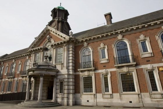 slate roofed, brick with stone pointing, 2-storey with round columned porch