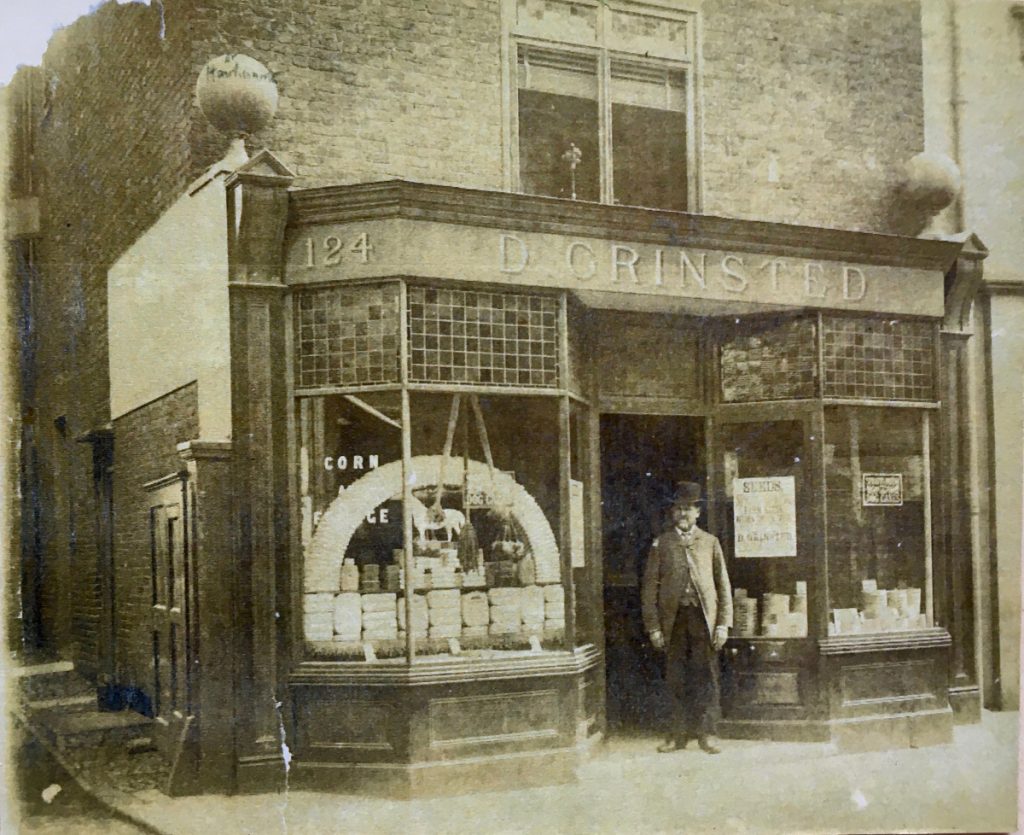 olde double fronted shop with shop keeper