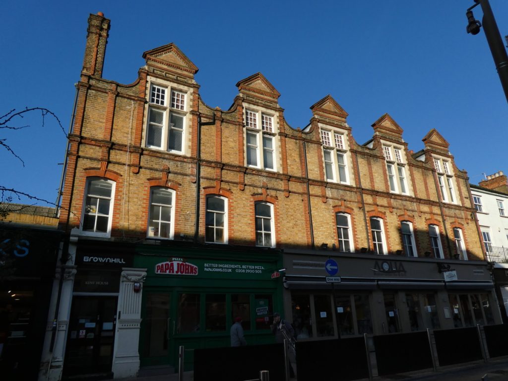 fine 3-storey shop terrace with triangular pediments over dormer windows