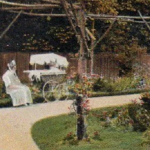 miserable nanny with elaborate high-wheeled pram