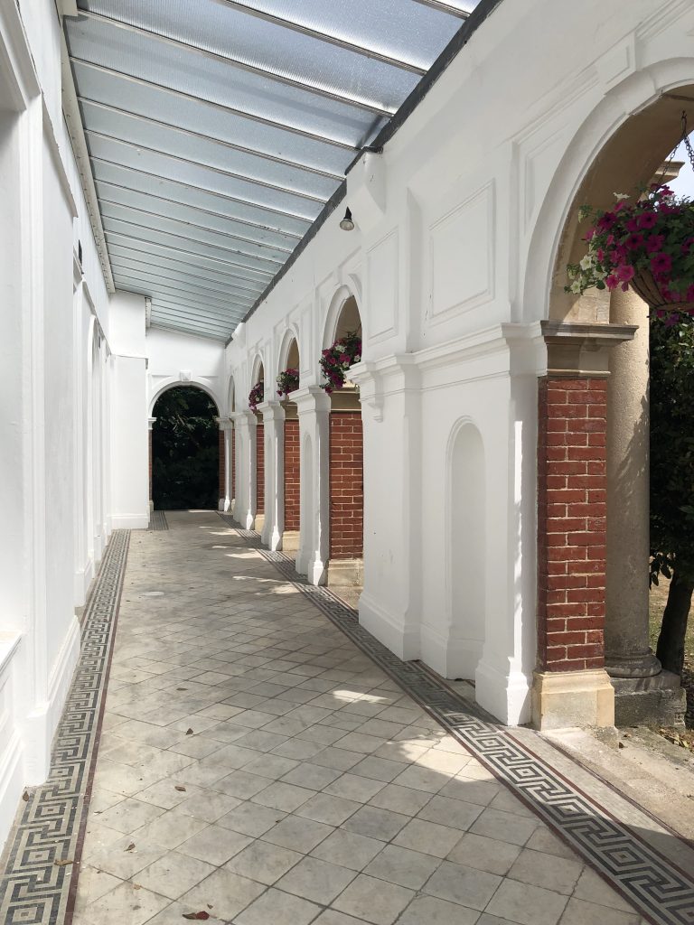 White washed colonnade with clear roof